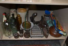 A selection of vintage glass and stone bottles, an enamel candlestick, weights, stone hot water