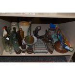 A selection of vintage glass and stone bottles, an enamel candlestick, weights, stone hot water