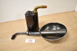 An Edwardian brass and faux tortoiseshell ear trumpet, measuring 11cm high, and another hearing