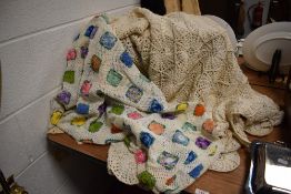 Two hand crocheted throws, one crocheted in fine cotton and having multicoloured floral granny