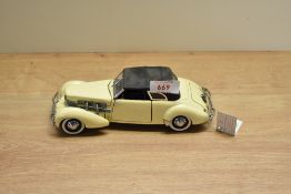 A 1989 Franklin Mint 1:24 scale Die-cast, 1937 Cord 812 Phaeton Coupe with tag and certificates,