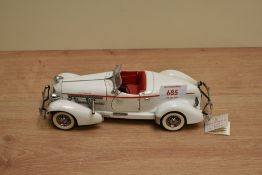 A 1990 Franklin Mint 1:24 scale Die-cast, 1935 Auburn 851 Speedster with tag and certificates, in