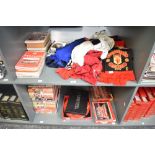 Two shelves of Manchester United Collectables including 1990's Team Shirts and T Shirts, 1990's