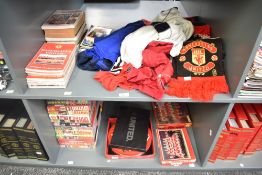 Two shelves of Manchester United Collectables including 1990's Team Shirts and T Shirts, 1990's