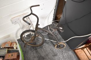 A vintage Childs Peddle Bike, Penny Farthing style