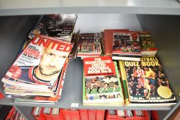 A shelf of Manchester United Year Books, Magazines, Football Books etc, 1980's onwards