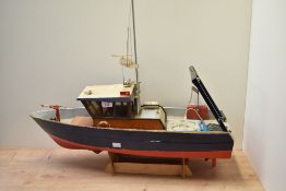 A wooden radio controlled Rescue Boat, on wooden plinth, length 70cm