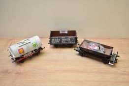 Six pieces of Peco 0 Gauge Plastic Track with three similar Wagons