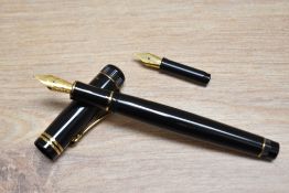 A boxed Kaweco Dia II cartridge fill fountain pen in black with gold trim having gold Bock nib.