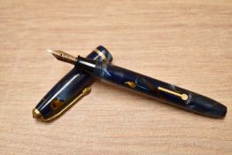 A Conway Stewart Dinkie 550 lever fill fountain pen in Blue/bronze marble with single band to the