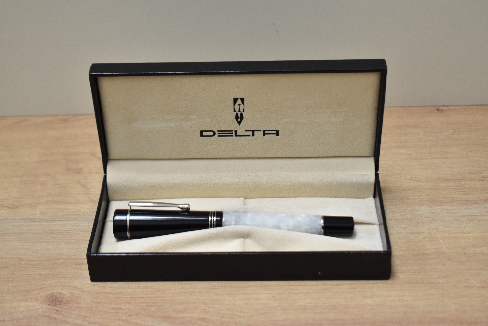 A boxed Delta Scrignor converter fill fountain pen in white marble with black cap having three