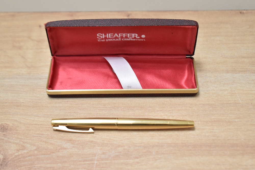 A Sheaffer Stylist push button converter fill fountain pen in 12K gold fill having Sheaffer 14K made