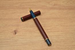 A boxed Parker Realto cartridge fill fountain pen in burgundy with gold trim having a Parker nib.
