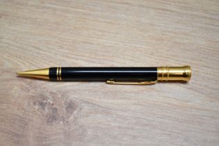 A boxed Parker Duofold International propelling pencil in black with gold trim