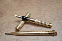 A boxed Eversharp Wahl lever fill ring topped fountain pen and propelling pencil set in gold fill