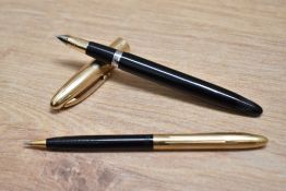 A boxed Sheaffer snorkel fill fountain pen and propelling pencil set in black with gold filled cap