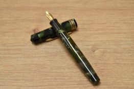 A Wahl Eversharp Doric One Shot vacuum fill fountain pen in green and black marble having