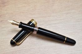 A boxed Aurora 88 piston fill fountain pen in black with gold trim having 14K 585 Aurora nib.