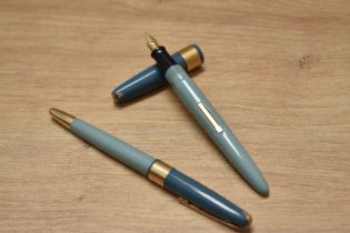 A boxed Stratford Regency lever fill fountain pen and propelling pencil set in teal with broad
