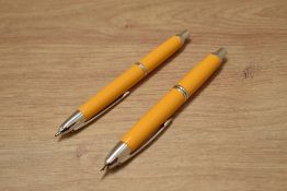 A boxed Pilot Vanishing point fountain pen and ballpoint pen set in deep yellow having Pilot 18K 750