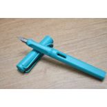A boxed Lamy Safari cartridge fill fountain pen in aquamarine with a Lamy M nib.