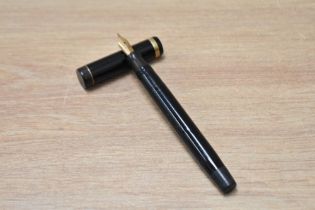 A Parker Duofold flat top button fill fountain pen in black with single band to the cap having