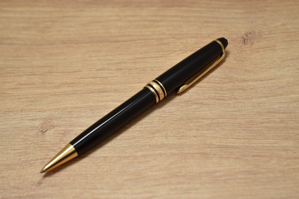 A Montblanc Meisterstuck Classique ballpoint pen in black with gold trim
