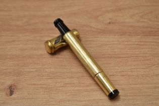 An Ebos safety 14k gold filled pen body, nib mechanism missing.