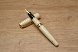 A boxed Waterman Charleston converter fill fountain pen in Ivory white with gold trim having