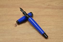 A Monteverde Invicta colour fusion converter fill fountain pen in blue with black trim having a