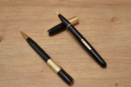 A Waterman 877 lever fill fountain pen and propelling pencil set in black with gold trim having