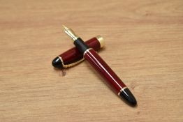 A Ginhao X450 converter fill fountain pen in black and red with gold trim having Ginhao 18K gold