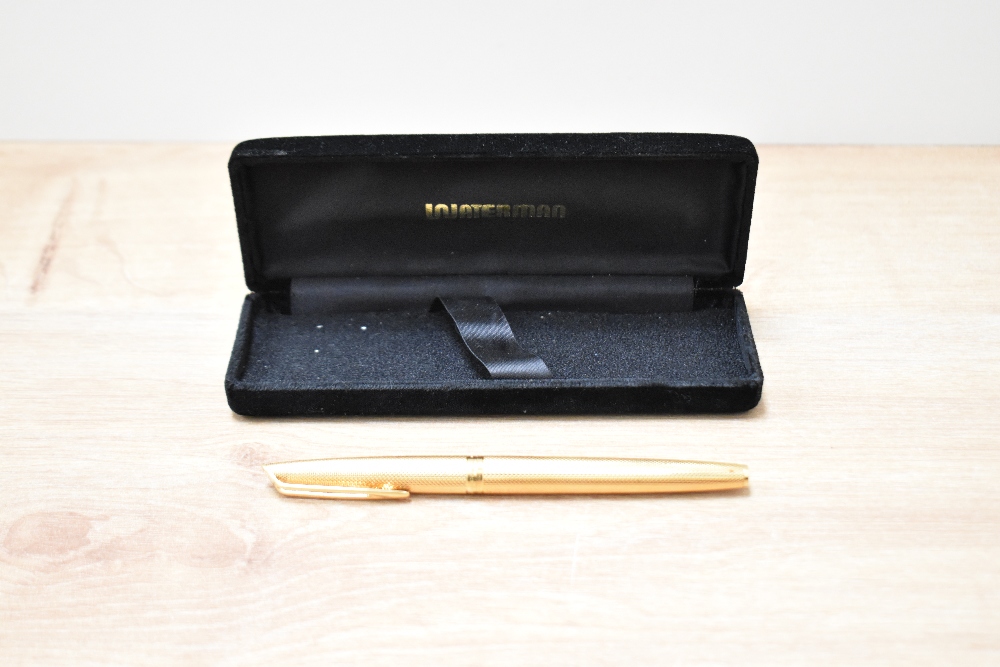 A boxed Waterman converter fill gold fill fountain pen in barleygrain engine turned design with