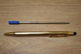 A boxed Cross gold plated ballpoint pen as new.