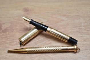 A Morrisons lever fill gold filled ring top fountain pen and propelling pencil set with