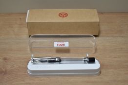 A TWSTI VAC 700R clear demonstrator plunger fill having TWSBI B nib in clear display box and outer