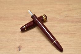 A boxed Mont Blanc Meisterstuck piston fill fountain pen in burgundy with gold trim having a 4810