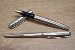 A boxed Parker 75 aerometric fill fountain pen and pencil set in silver plated milleraies pattern