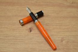 A Monteverde Jewelria converter fill fountain pen in orange with chrome trim having a Monteverde USA