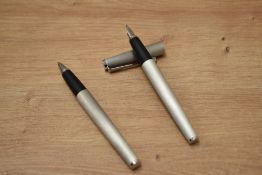 A boxed Lamy Studio cartridge fill fountain pen and rollerball set in brushed steel having M Lamy