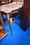 An early 20th Century mahogany occasional table having shaped top and undertier