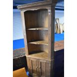 A natural pine corner shelf with cupboard under, height approx. 191cm