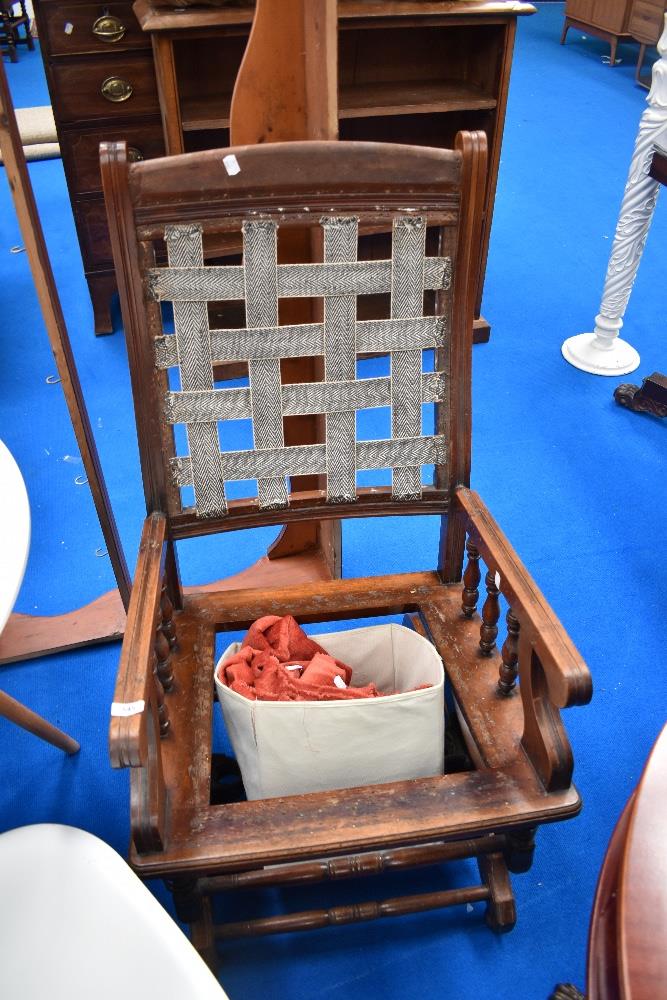 A Victorian mahogany American rocker, in need of restoration