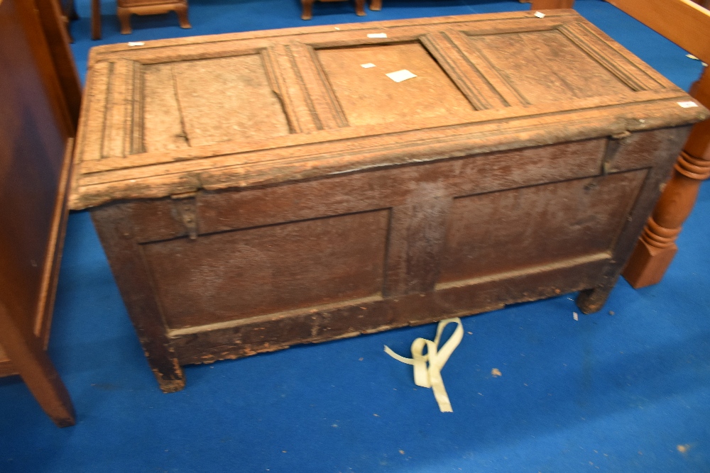 A period oak three panelled kist having carved decoration, approx dimensions W122 D55 H63cm