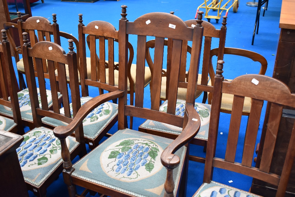 A set of seven, six plus one early 20th Century mahogany dining chairs with later woolwork seats