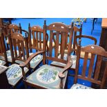 A set of seven, six plus one early 20th Century mahogany dining chairs with later woolwork seats