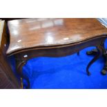 An Edwardian mahogany fold over card table on shaped legs, width approx. 91