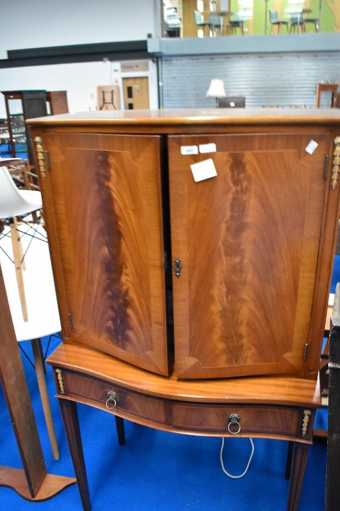 A reproduction cocktail cabinet, dimensions approx H154 W88 D44cm