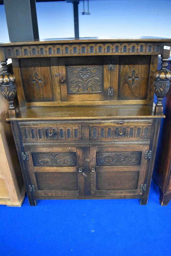An early 20th Century oak court cupboard with carved panels, width approx. 106cm