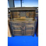 An early 20th Century oak court cupboard with carved panels, width approx. 106cm